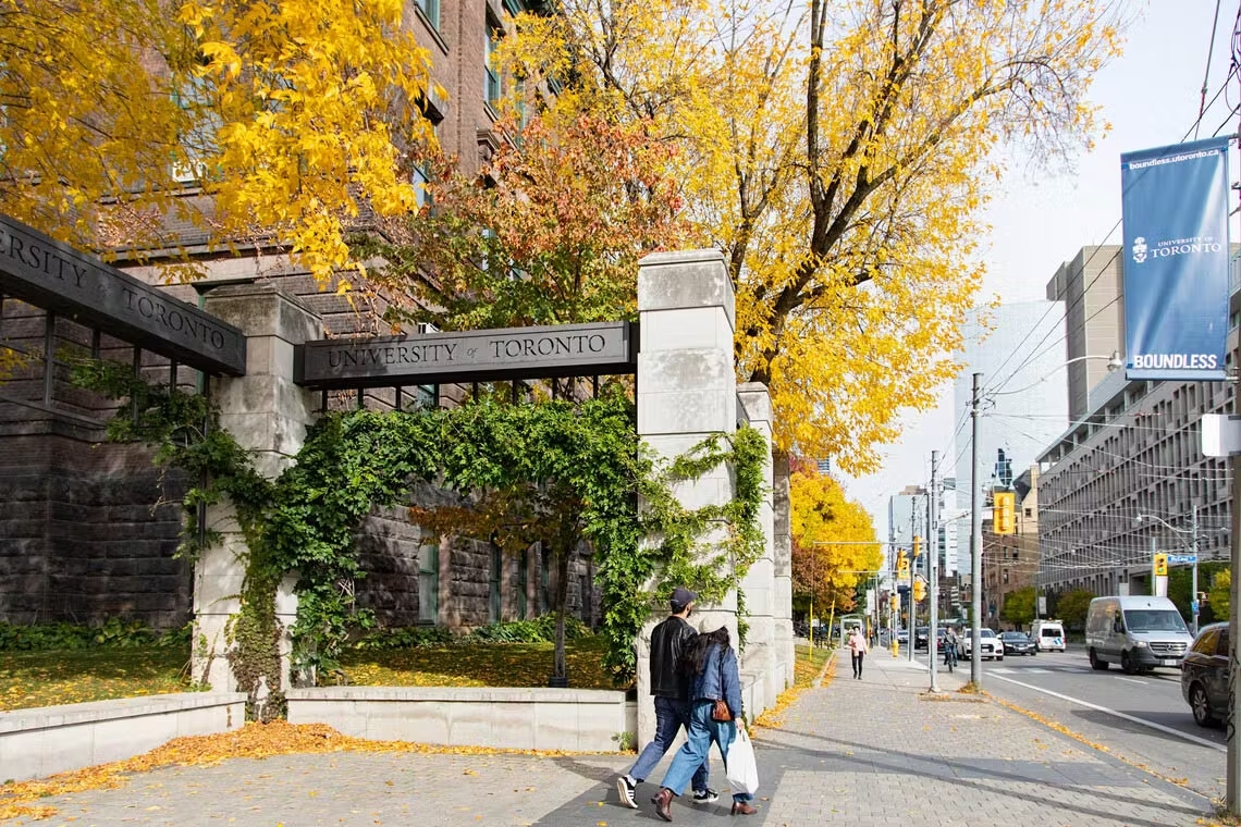 students walking around the university of toronto campus in the fall